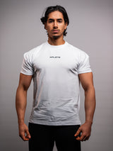 Model wearing the white AFLETE Essential Urban T-shirt 011, tshirt front view