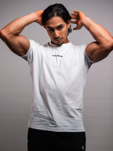 Model wearing the white AFLETE Essential Urban T-shirt 011, tshirt three quarter view