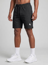 Model wearing the black AFLETE Essential Urban shorts 012, shorts front view