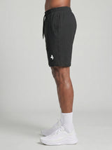 Model wearing the black AFLETE Essential Urban shorts 012, shorts side view