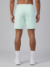 Model wearing the light mint AFLETE Essential Urban shorts 012, shorts back view