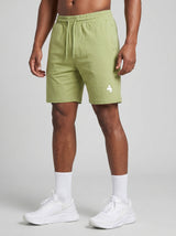 Model wearing the olive green AFLETE Essential Urban shorts 012, shorts front view