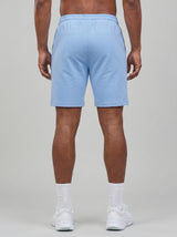 Model wearing the periwinkle blue AFLETE Essential Urban shorts 012, shorts back view