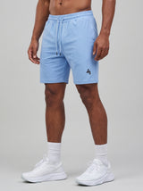 Model wearing the periwinkle blue AFLETE Essential Urban shorts 012, shorts front view