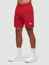 Model wearing the red AFLETE Essential Urban shorts 012, shorts front view
