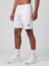 Model wearing the white AFLETE Essential Urban shorts 012, shorts front view