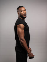 Model wearing the black AFLETE workout tank top 014, tank top side view
