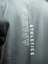 Sage Grey AFLETE workout tank top 014, hem logo close up