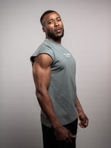 Model wearing the sage grey AFLETE workout tank top 014, tank top side view