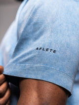 Blue AFLETE Washed Essential oversized T-shirt 015, sleeve wordmark close up