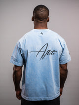 Model wearing the blue AFLETE Washed Essential oversized T-shirt 015, tshirt back view