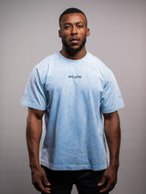 Model wearing the blue AFLETE Washed Essential oversized T-shirt 015, tshirt front view