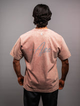 Model wearing the clay pink AFLETE Washed Essential oversized T-shirt 015, tshirt back view