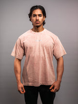 Model wearing the clay pink AFLETE Washed Essential oversized T-shirt 015, tshirt front view