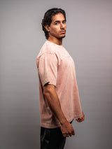 Model wearing the clay pink AFLETE Washed Essential oversized T-shirt 015, tshirt left side view