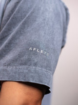 Grey Ash AFLETE Washed Essential oversized T-shirt 015, sleeve geometric logo close up