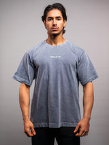 Model wearing the grey ash AFLETE Washed Essential oversized T-shirt 015, tshirt front view