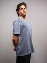 Model wearing the grey ash AFLETE Washed Essential oversized T-shirt 015, tshirt left side view