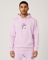 Model wearing the rose pink AFLETE Urban hoodie 016, hoodie front hands in pockets
