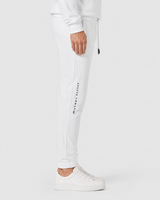 Model wearing the white AFLETE Urban joggers 017, joggers side view