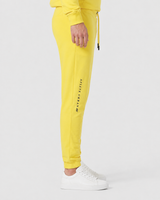 Model wearing the yellow AFLETE Urban joggers 017, joggers side view