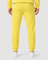Model wearing the yellow AFLETE Urban joggers 017, joggers three quarter view