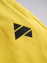 Yellow AFLETE Urban joggers 017, thigh logo close up