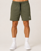 Model wearing the olive green AFLETE Core cotton shorts 018, shorts front view