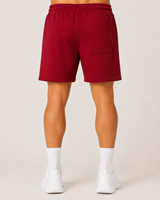 Model wearing the red AFLETE Core cotton shorts 018, shorts back view