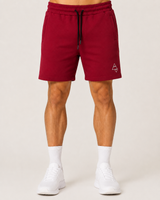 Model wearing the red AFLETE Core cotton shorts 018, shorts front view