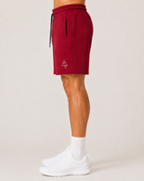 Model wearing the red AFLETE Core cotton shorts 018, shorts side view